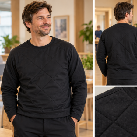 GOZZ zwarte anti-scheur trui van Cordura Ripstop met ruitvormige doorstikking, gedragen door een man in een zorgomgeving.